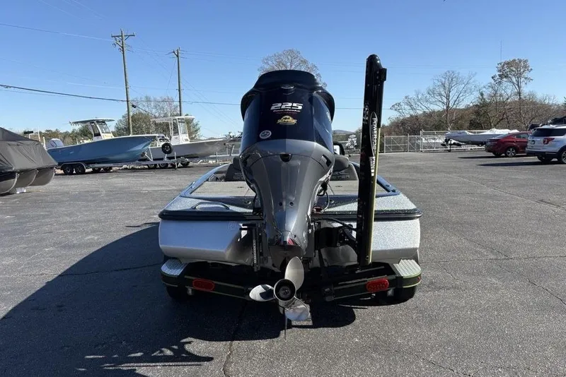 Slide: The Image of 2018 Skeeter ZX225 boat with powerful outboard motor in a parking lot. - 8