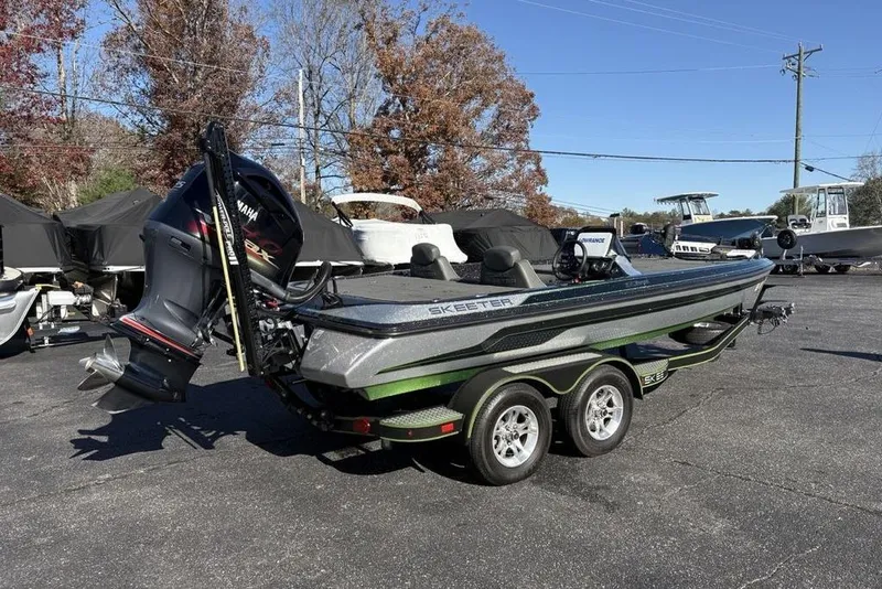 Slide: The Image of 2018 Skeeter ZX225 bass boat with Yamaha outboard motor on a trailer. - 9