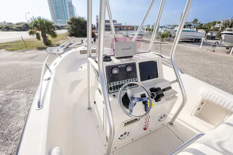 Slide: The Image of 2004 Key West 186 Center Console boat with Garmin navigation, docked near a coastal area. - 14
