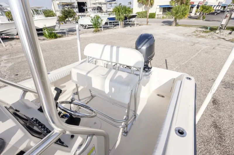 Slide: The Image of 2004 Key West 186 Center Console boat with steering wheel and seating, parked outdoors. - 20