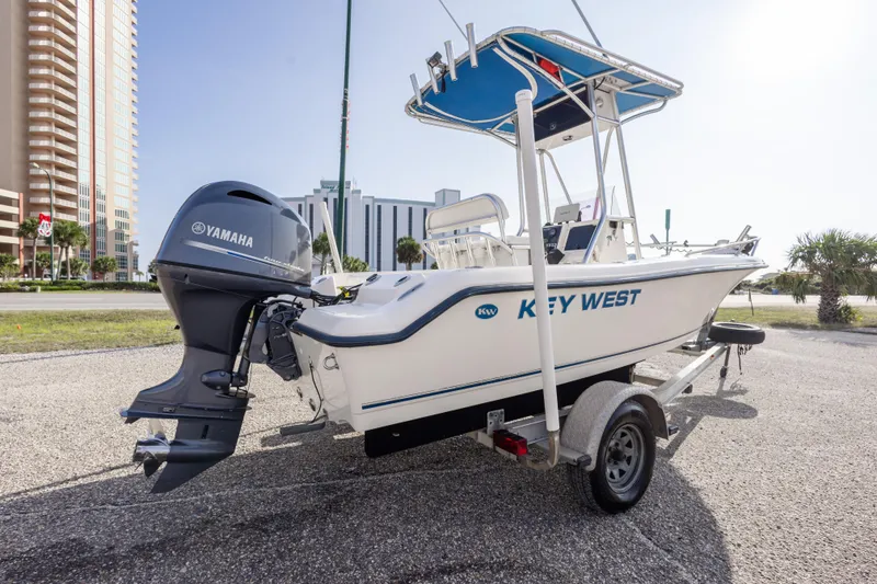 Slide: The Image of 2004 Key West 186 Center Console boat with Yamaha engine on trailer, urban background. - 7