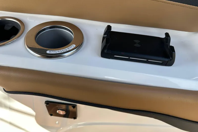 Slide: The Image of 2024 Hurricane SunDeck 2600 OB boat console with cup holder and wireless charger. - 13