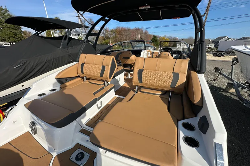 Slide: The Image of 2024 Hurricane SunDeck 2600 OB boat with tan seating and sleek design. - 14