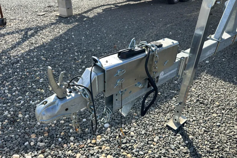 Slide: The Image of Trailer hitch for 2024 Hurricane SunDeck 2600 OB on gravel surface. - 20