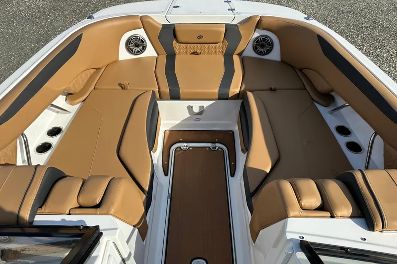 Slide: The Image of 2024 Hurricane SunDeck 2600 OB boat interior with tan seating and cup holders. - 7