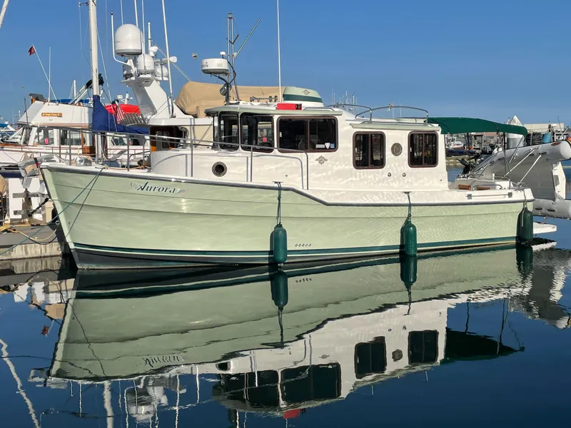The Image of 2010 Ranger Tugs R-29 boat docked in harbor, calm water. - 0