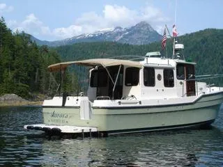 Slide: The Image of 2010 Ranger Tugs R-29 boat on a serene lake. - 2