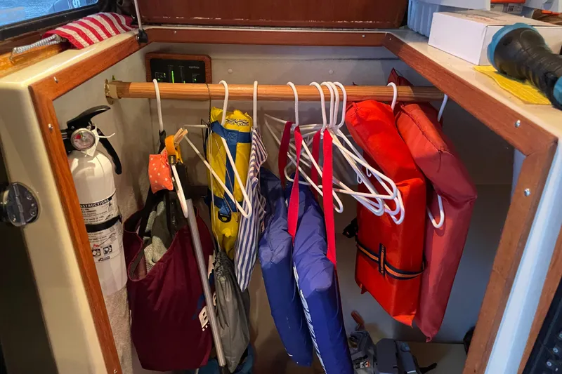 Slide: The Image of Storage area in a 2010 Ranger Tugs R-29 with life jackets and a fire extinguisher. - 24