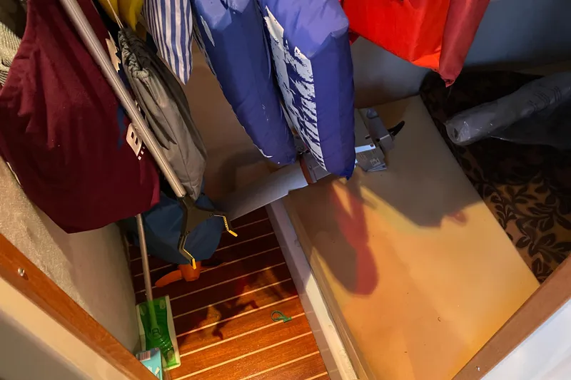 Slide: The Image of Storage area inside a 2010 Ranger Tugs R-29 boat with life jackets and equipment. - 25