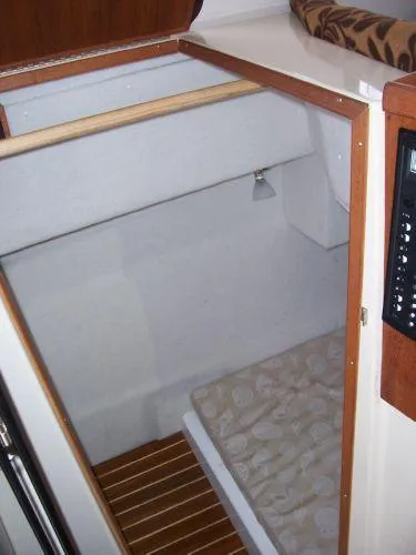 Slide: The Image of Interior of 2010 Ranger Tugs R-29 with wood flooring and bed. - 26