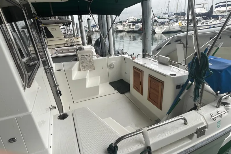 Slide: The Image of 2010 Ranger Tugs R-29 boat interior at marina, featuring seating and storage compartments. - 8