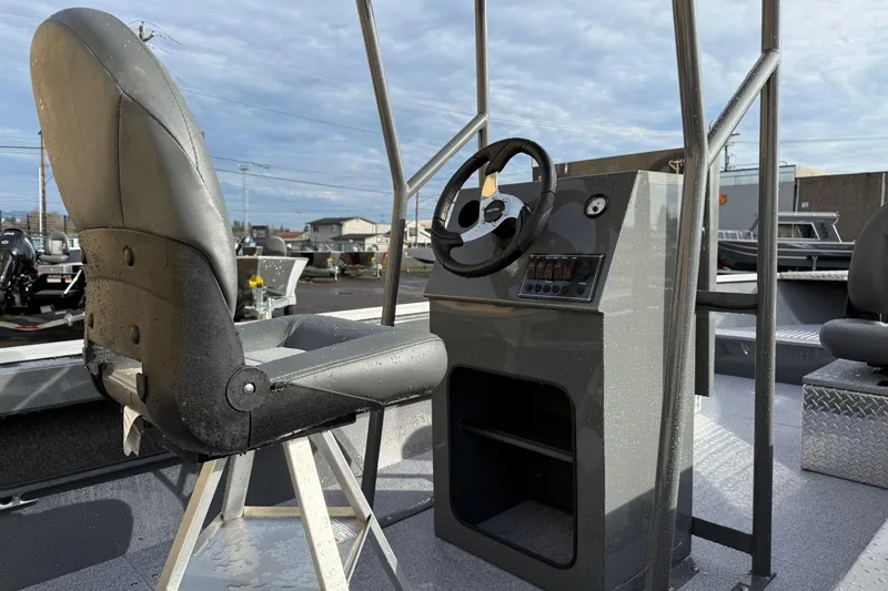 Slide: The Image of 2026 Fish Rite Angler 18 boat interior with steering console and seating. - 10
