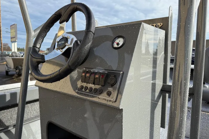 Slide: The Image of 2026 Fish Rite Angler 18 boat dashboard with steering wheel and control panel. - 11