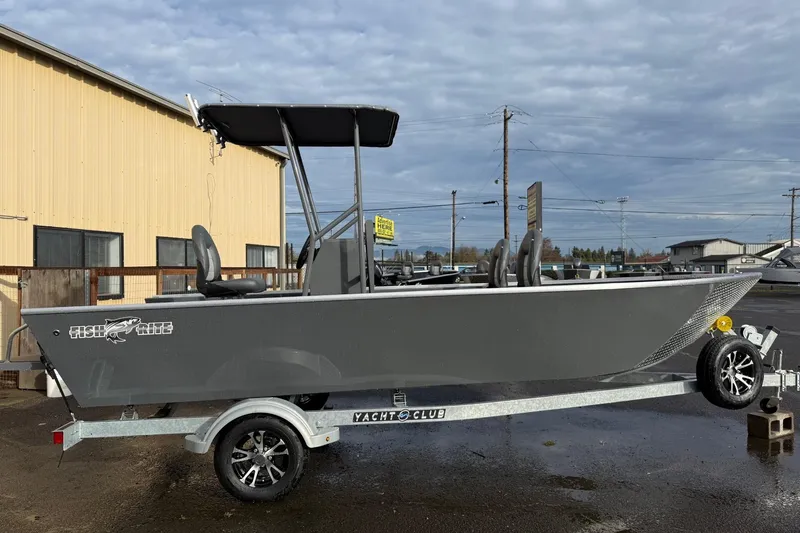 Slide: The Image of 2026 Fish Rite Angler 18 boat on trailer, parked outdoors under cloudy sky. - 5