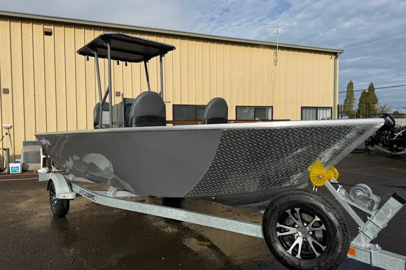Slide: The Image of 2026 Fish Rite Angler 18 boat on trailer, parked outside a beige building. - 6
