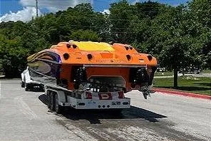 Slide: The Image of 2008 Nor-Tech 3600 Supercat boat on trailer, vibrant orange and purple design. - 10