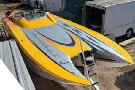 Slide: The Image of 2008 Nor-Tech 3600 Supercat powerboat with vibrant yellow and gray design, docked outdoors. - 2
