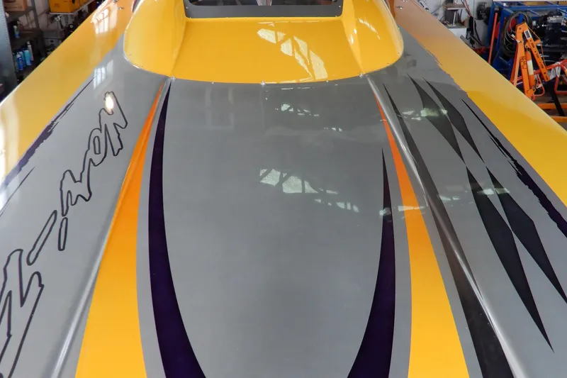 Slide: The Image of 2008 Nor-Tech 3600 Supercat boat with vibrant yellow and gray design. - 23