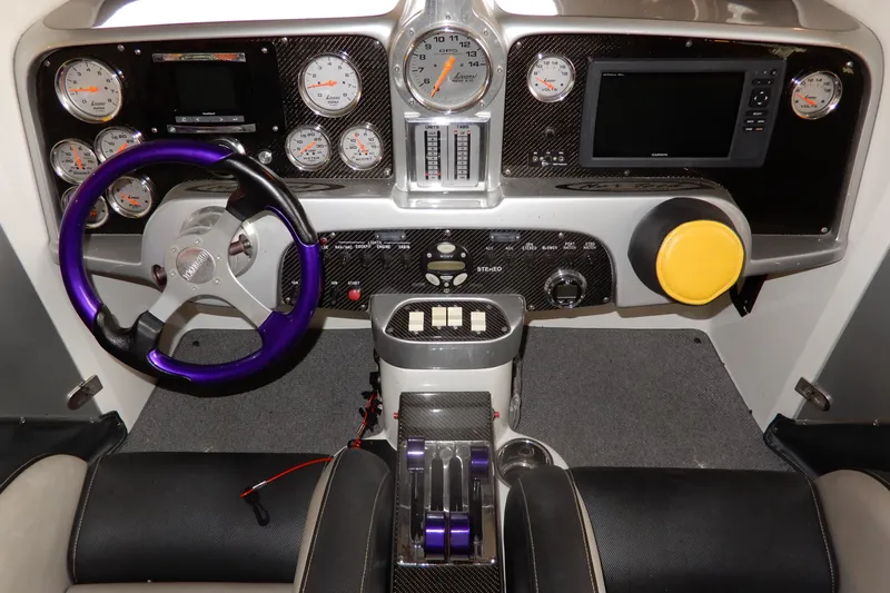 Slide: The Image of 2008 Nor-Tech 3600 Supercat dashboard with gauges, purple steering wheel, and carbon fiber accents. - 32