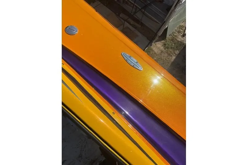 Slide: The Image of 2008 Nor-Tech 3600 Supercat with vibrant orange and purple detailing. - 6