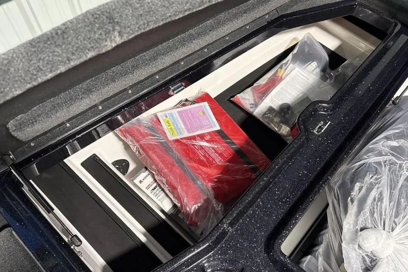 Slide: The Image of Storage compartment of 2026 Skeeter ZXE21 boat with safety equipment and accessories. - 10