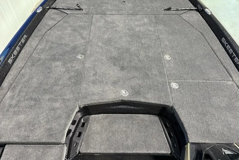 Slide: The Image of 2026 Skeeter ZXE21 boat deck with gray carpet and storage compartments. - 11