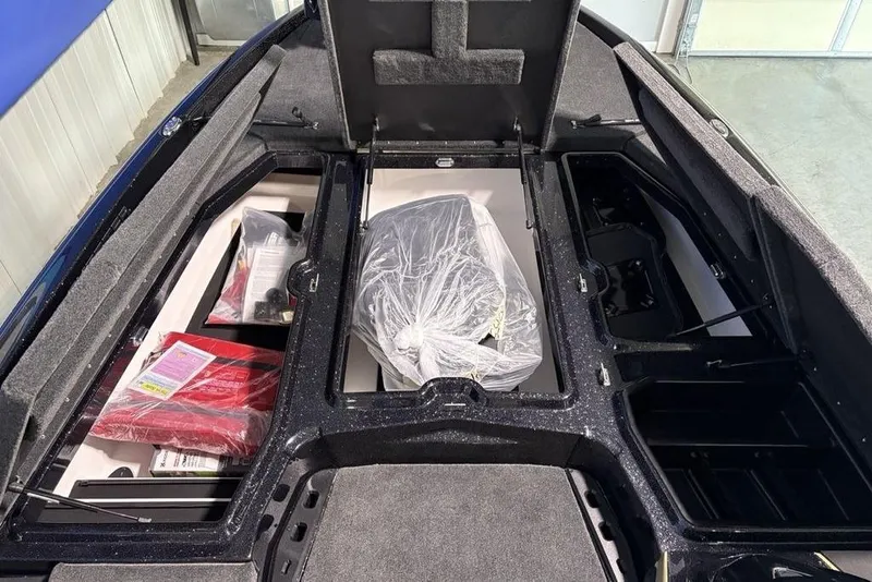 Slide: The Image of 2026 Skeeter ZXE21 boat storage compartments with equipment and accessories. - 13
