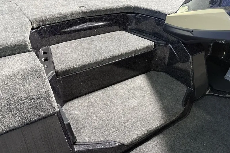 Slide: The Image of Interior of 2026 Skeeter ZXE21 boat with carpeted steps and seating area. - 15