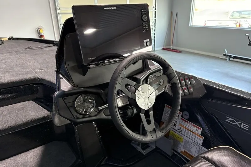 Slide: The Image of 2026 Skeeter ZXE21 boat cockpit with steering wheel and advanced navigation display. - 25
