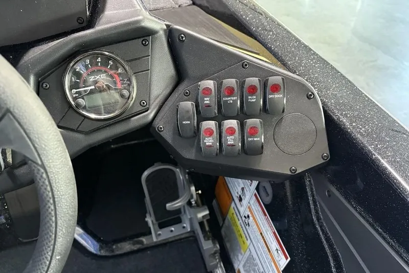 Slide: The Image of Control panel of 2026 Skeeter ZXE21 boat with switches and gauge. - 26