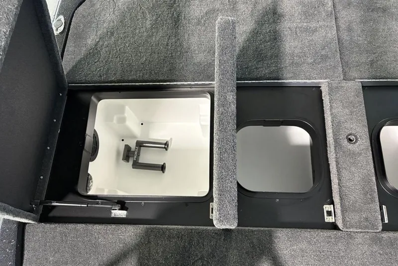 Slide: The Image of 2026 Skeeter ZXE21 boat storage compartments with carpeted lids and organized interior. - 30