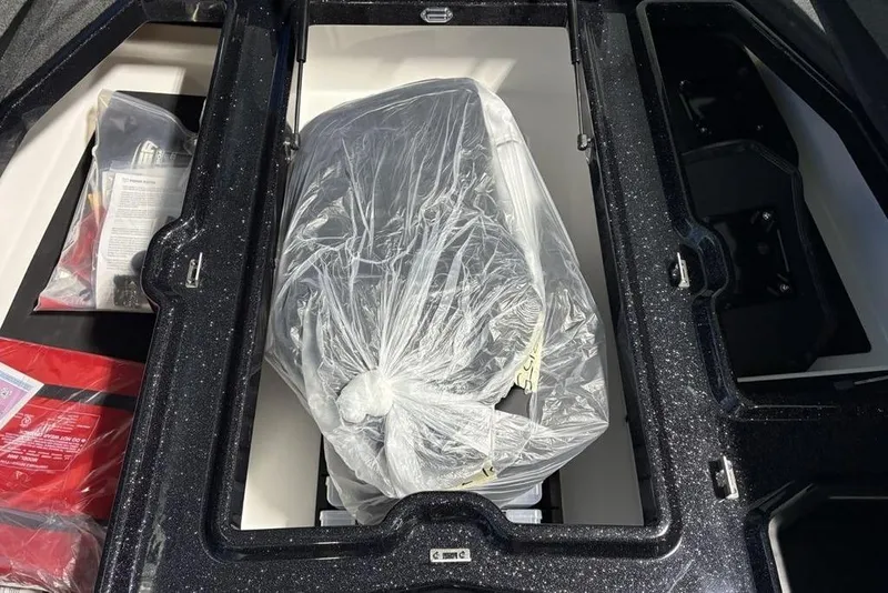 Slide: The Image of 2026 Skeeter ZXE21 boat storage compartment with packaged equipment inside. - 9