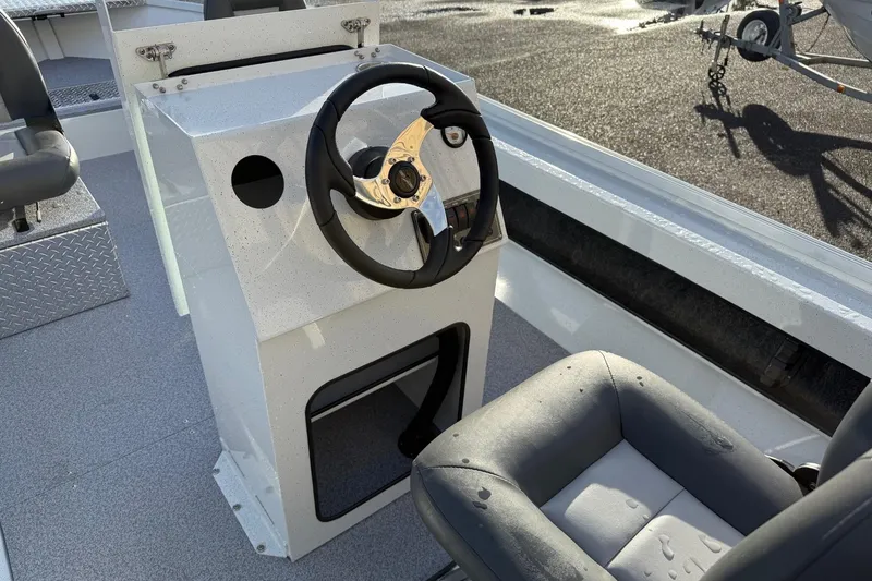 Slide: The Image of 2026 Fish Rite Angler 18 boat interior with steering wheel and seating. - 12