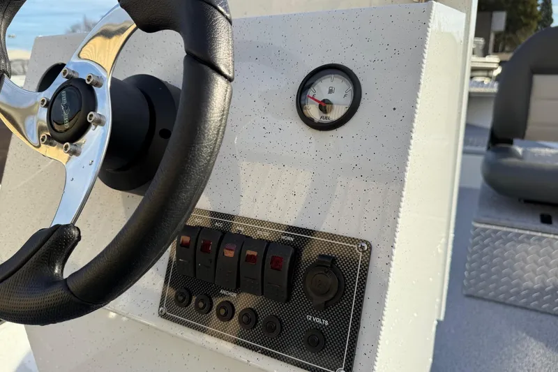 Slide: The Image of Steering console of 2026 Fish Rite Angler 18 boat with fuel gauge and controls. - 14