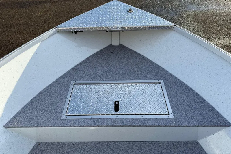 Slide: The Image of 2026 Fish Rite Angler 18 boat deck with diamond plate storage hatch. - 15