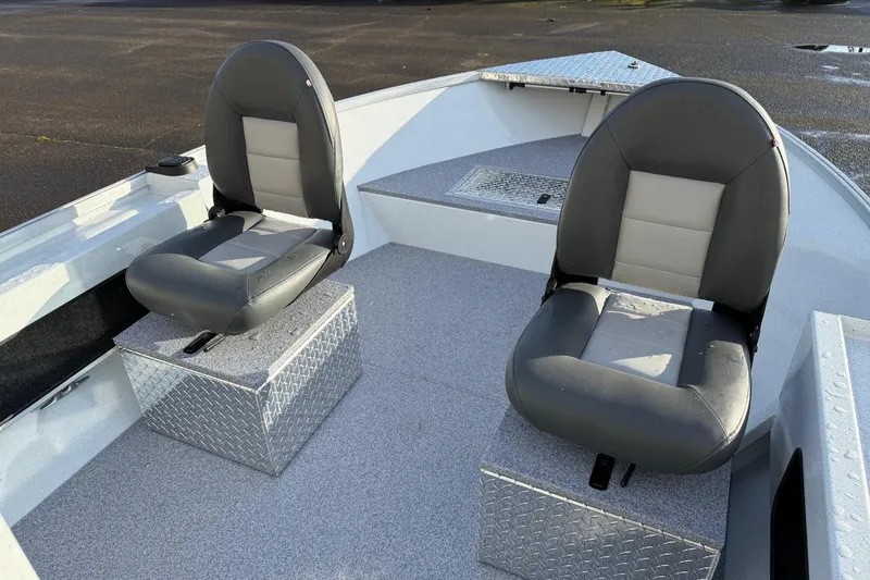 Slide: The Image of 2026 Fish Rite Angler 18 boat interior with two cushioned seats on metal boxes. - 16