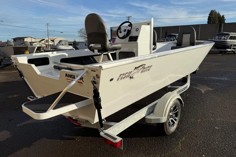 Slide: The Image of 2026 Fish Rite Angler 18 boat on trailer, parked outdoors, showcasing sleek design. - 4