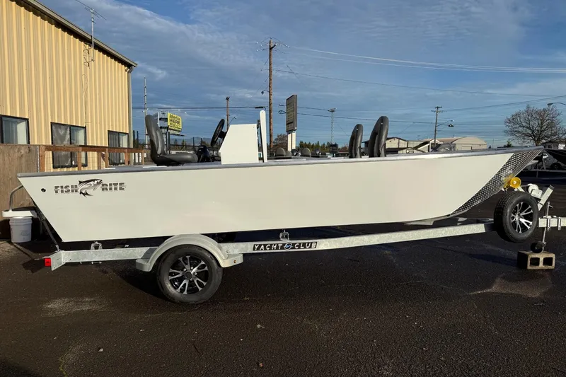 Slide: The Image of 2026 Fish Rite Angler 18 boat on trailer, parked outside a building. - 5