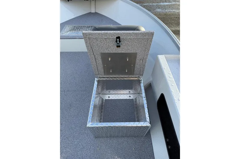 Slide: The Image of Open storage compartment on 2026 Fish Rite Angler 18 boat, featuring diamond plate design. - 9