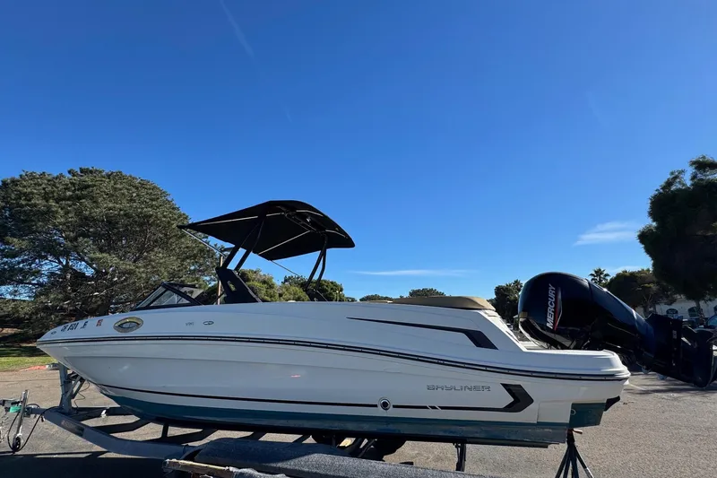 Slide: The Image of 2022 Bayliner VR6 Bowrider OB on trailer under clear blue sky. - 13