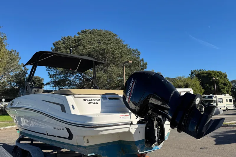 Slide: The Image of 2022 Bayliner VR6 Bowrider OB with Mercury outboard motor, parked outdoors under clear blue sky. - 14