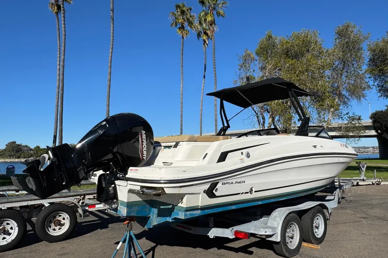 Slide: The Image of 2022 Bayliner VR6 Bowrider OB on trailer, parked near palm trees and water. - 17