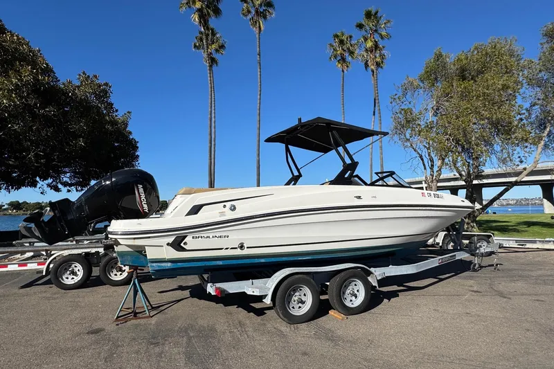 Slide: The Image of 2022 Bayliner VR6 Bowrider OB on trailer, parked near palm trees and water. - 19