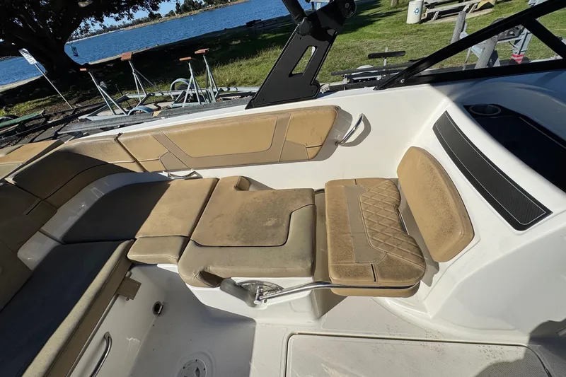 Slide: The Image of 2022 Bayliner VR6 Bowrider OB interior with tan seating and lake view. - 26