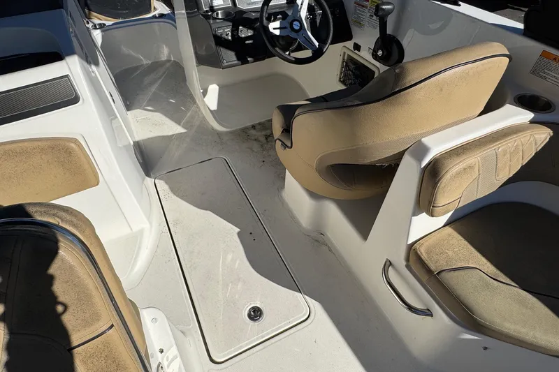 Slide: The Image of 2022 Bayliner VR6 Bowrider OB interior with beige seating and steering console. - 29