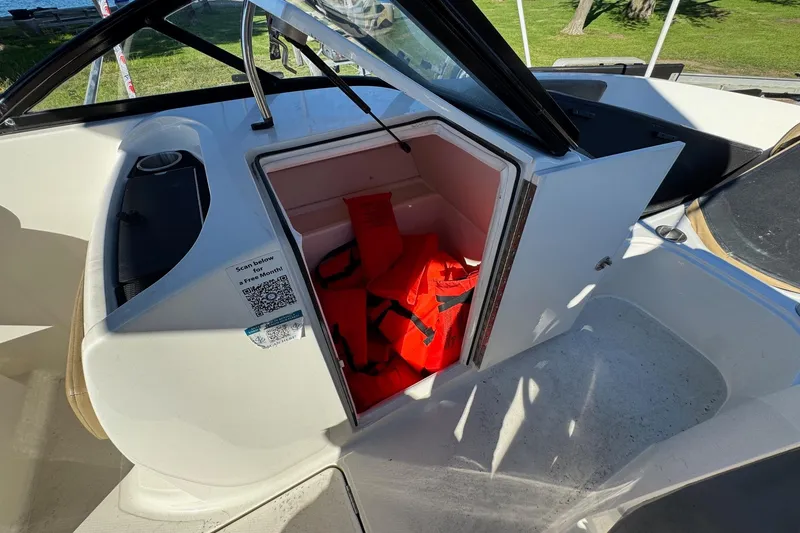 Slide: The Image of 2022 Bayliner VR6 Bowrider OB storage compartment with life jackets inside. - 38