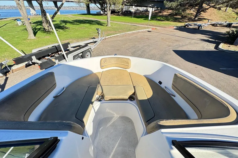 Slide: The Image of 2022 Bayliner VR6 Bowrider OB interior with spacious seating and scenic waterfront view. - 40