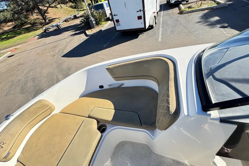 Slide: The Image of 2022 Bayliner VR6 Bowrider OB boat interior with tan seating in a parking lot. - 41