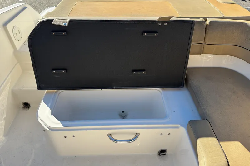 Slide: The Image of 2022 Bayliner VR6 Bowrider OB storage compartment with open lid, showcasing interior space. - 46
