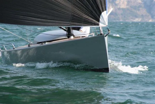 Slide: The Image of Sleek Brenta 30 sailboat cutting through waves, 2026 model, with black sails. - 15